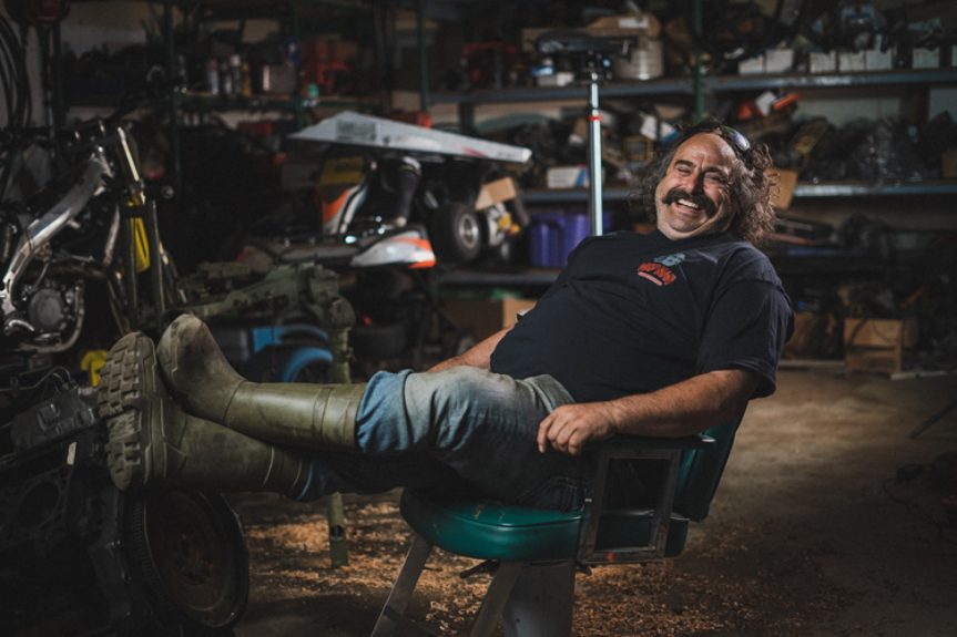 Mechanic relaxing in a car repair shop